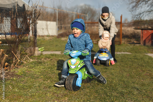 Wallpaper Mural Little boy riding on the toy motobike in the yard. Torontodigital.ca