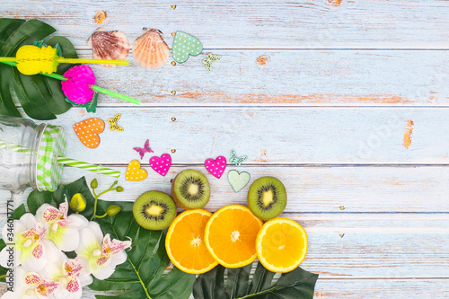 Summer vacation concept with leaves and sliced fruit 