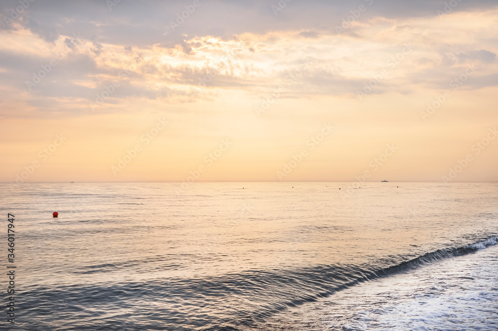 Beautiful sunset over the calm sea on a cloudy hot summer evening. Beautiful sunset over the calm sea on a cloudy hot summer evening.