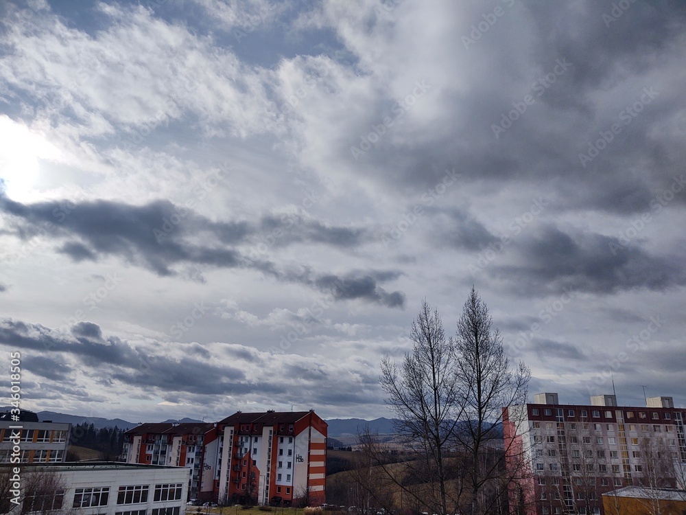 Sunrise and sunset, beautiful clouds over the meadow, hills and buildings in the town. Slovakia Sunrise and sunset, beautiful clouds over the meadow, hills and buildings in the town. Slovakia