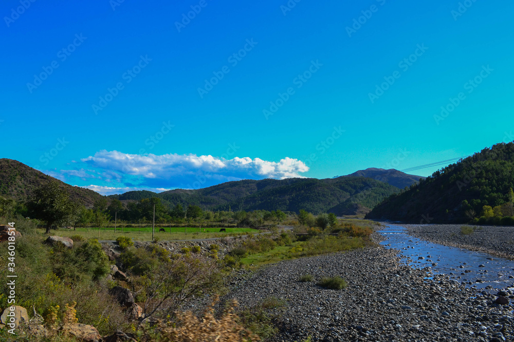 Mountain landscape with blue stream and sky, Albania