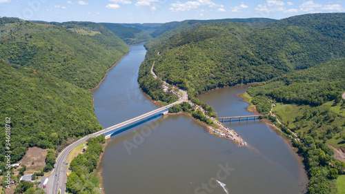 Aerial view of the Pelotas River bridge with its green mountains. Border between Rio Grande do Sul and Santa Catarina, Brazil photo