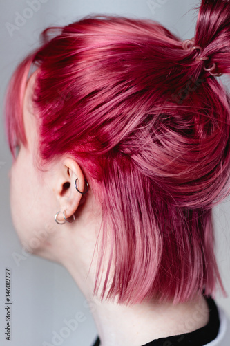 Woman with pink hair. The view from the back, the face is not visible.