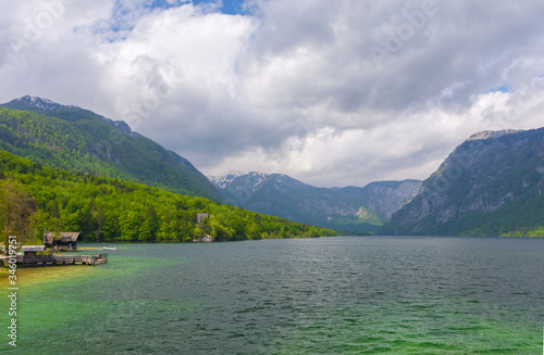 Clear blue water of lake Bohinj, Julian Alps, the largest permanent lake in Slovenia. Beautiful mountain landscape in spring.