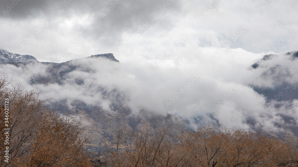 Fototapeta premium Clouds over mountain range after rainstorm in Utah.