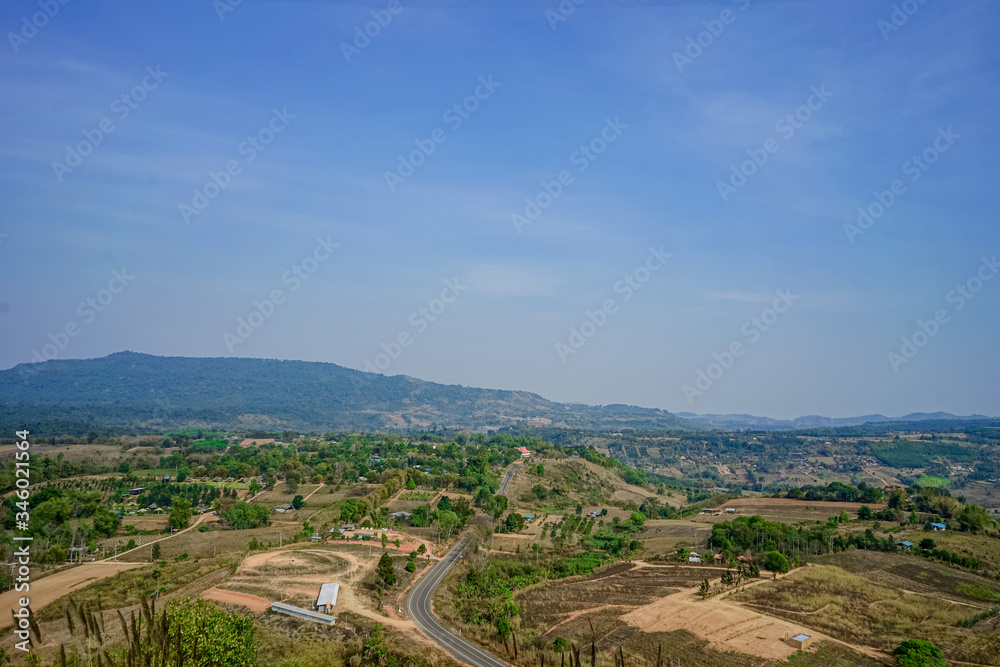 A picture of a landscape of a community in a central valley with mountains and blue skies. A picture of a landscape of a community in a central valley with mountains and blue skies.
