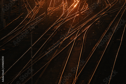 Railroad tracks on sunset background. Trains in the depot. Railway at sunset.