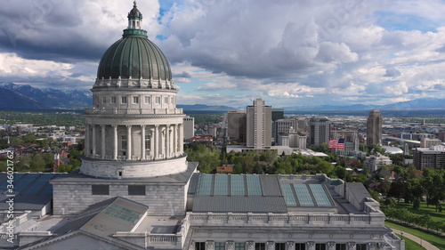 Aerial view of downtown Salt Lake City while flying past the Capitol building moving past the dome.