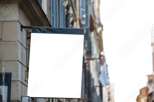 Hanging rectangular blank flag on the street in the city - Image