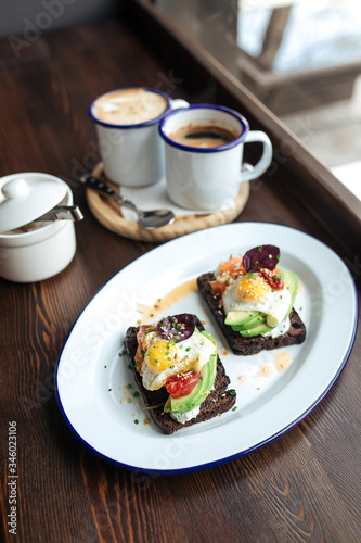 Breakfast rye toast with avocado poched egg salmon
