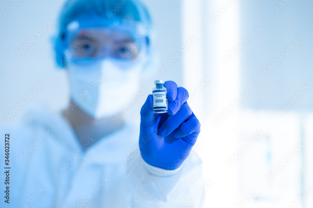 Scientists in the laboratory holding a bottle of coronavirus vaccine. The success of the invention vaccine for Covid-19. Part of the 2019-2020 global pandemic. Scientists in the laboratory holding a bottle of coronavirus vaccine. The success of the invention vaccine for Covid-19. Part of the 2019-2020 global pandemic.