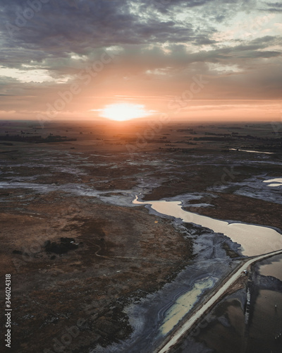 Aerial view of the sun rising on the horizon in the countryside, in Argentina.
