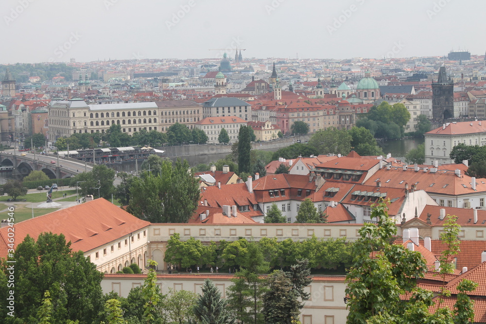 view overview from a height in Prague Czech Republic red roofs of houses old town square you can see the old castle