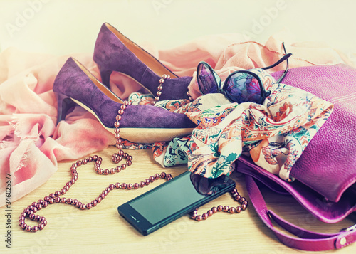 Female shoes and accessories on wooden background, selective focus.