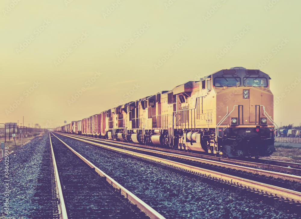 Obraz premium Freight train travelling through Arizona at Sunset 