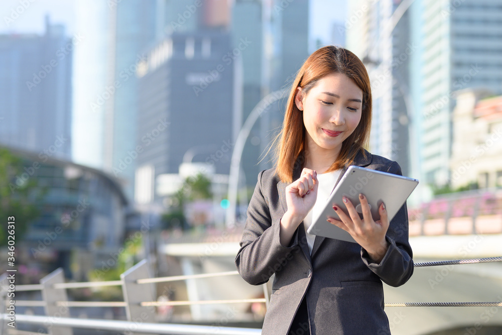 Young Asian business woman using laptop working in urban city. Concept of research, telelcommunication and technology Young Asian business woman using laptop working in urban city. Concept of research, telelcommunication and technology