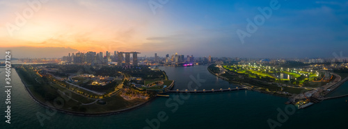 Drone view of Singapore Gardens by the Bay botanical gardens and Marina bay sands at twilight