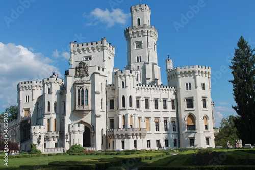 white light castle against the blue sky and green grass lawn