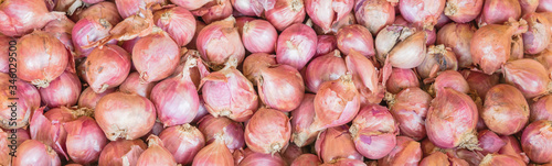 Panoramic view heap of raw yellow onions on display at market stand in Little India, Singapore