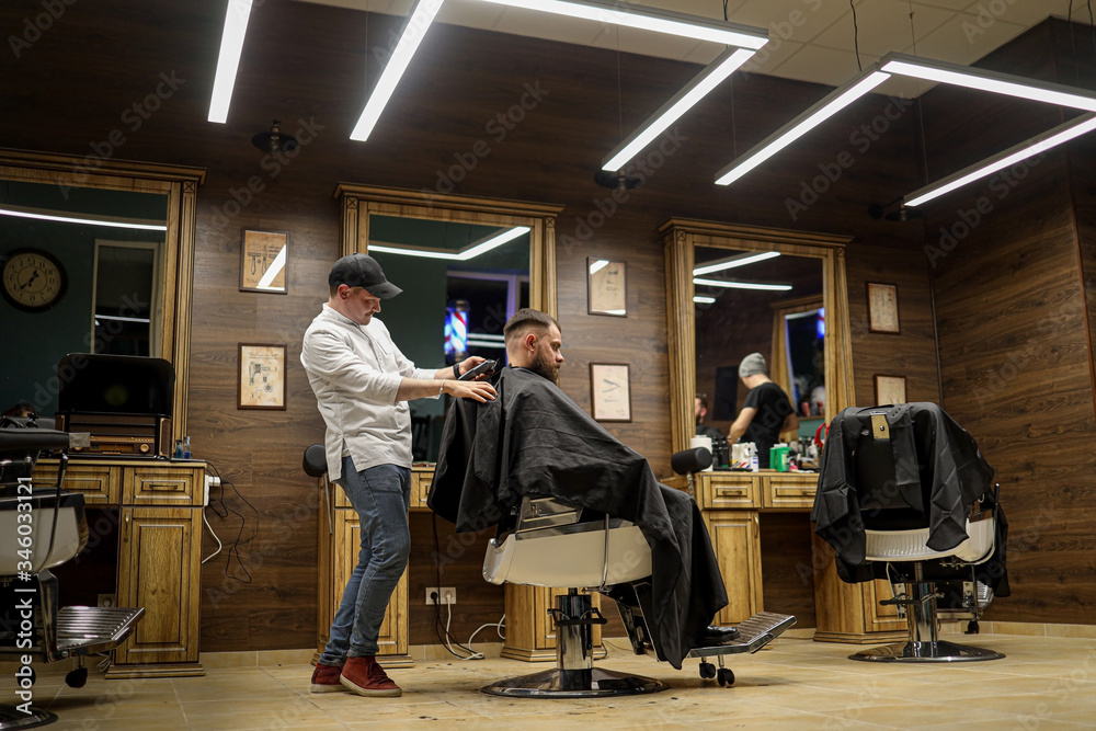 barber making a haircut in barbershop barber making a haircut in barbershop
