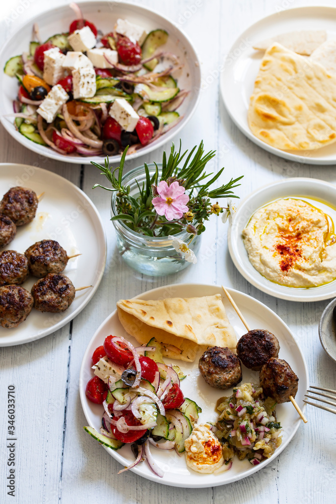 Greek meze meal with lamb meatballs, hummus and salad