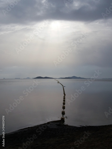  dividing floats for boats on the background of the sea with the beach and the horizon on the background of dawn