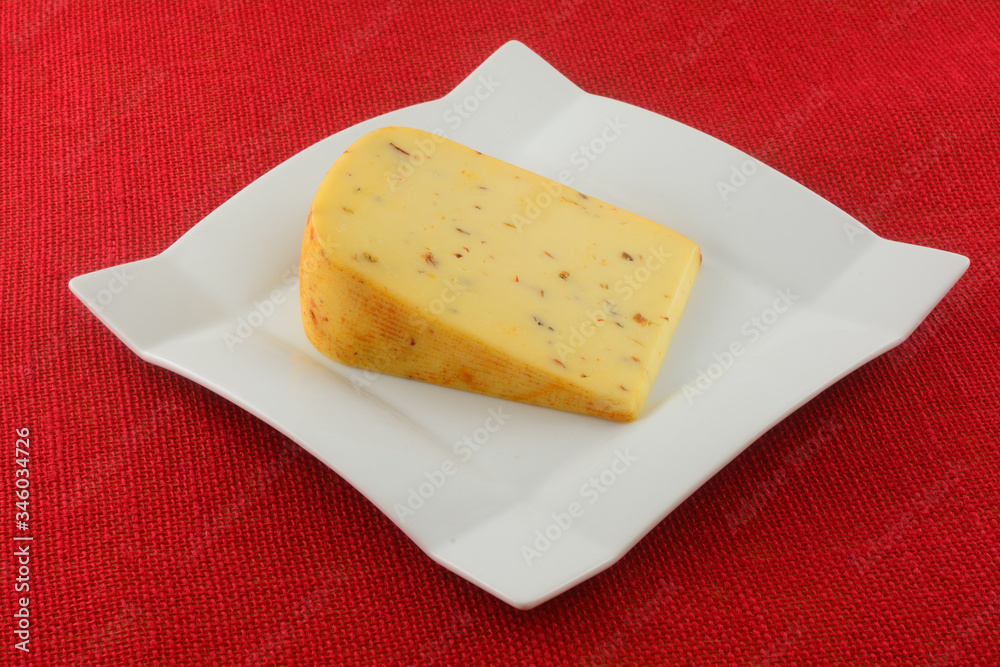 Φωτογραφία Spicy hot pepper gouda cheese with jalapeno, chipotle and habanero peppers on wh