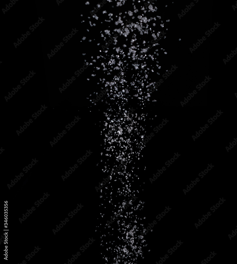 Texture of pouring sugar on a black background