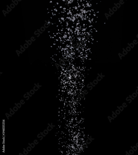Texture of pouring sugar on a black background