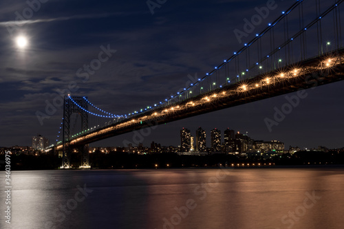 Illuminated George Washington Bridge at night with full moon