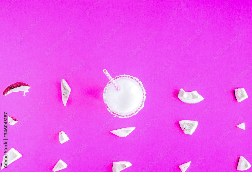 Fototapeta premium cocktail with coconut on purple background top view pattern