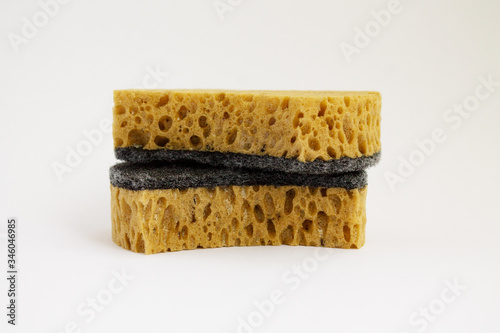 two dish washing sponges yellow clean on a white background lie on top of each other