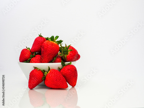 bowl of fresh strawberries on white background
