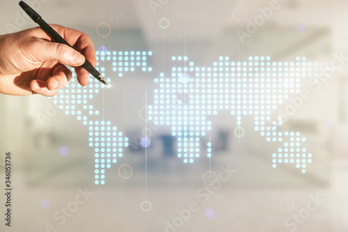 Multi exposure of man hand with pen working with abstract graphic world map on blurred office background, connection and communication concept