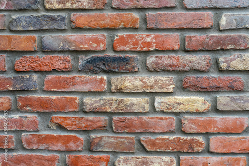 Ancient wall made of darkened red brick