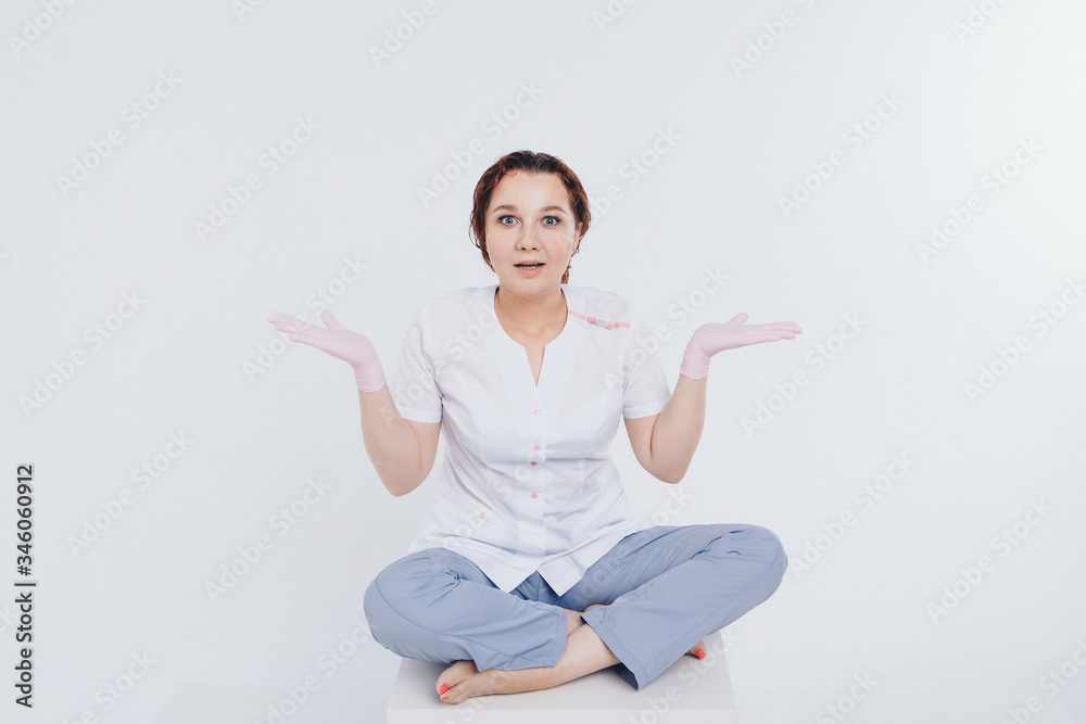 doctor in rubber gloves raises his hands up. girl wears protective equipment during epidemic. Act of donation. antiseptics and medical equipment on white background. Imitation of greeting. Copy space doctor in rubber gloves raises his hands up. girl wears protective equipment during epidemic. Act of donation. antiseptics and medical equipment on white background. Imitation of greeting. Copy space