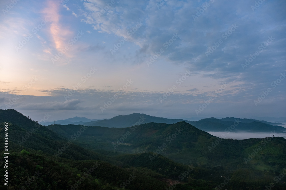 Scenery of mountains under mist in the morning in Thailand.