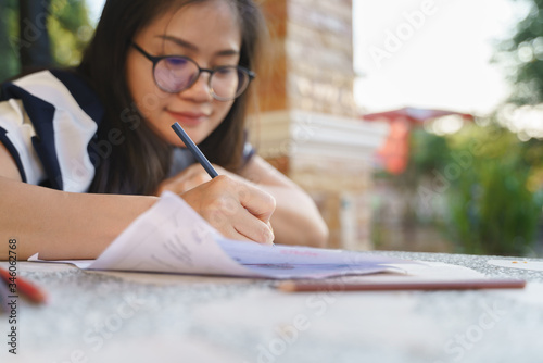 Asian woman studying and doing homework