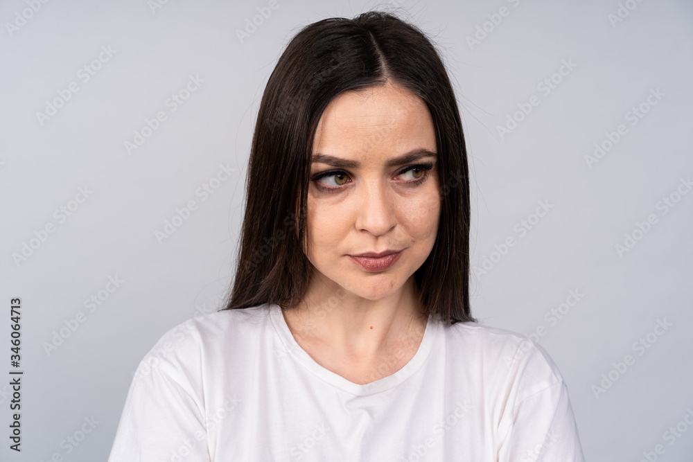 Portrait of a young girl with dissolved hair, she looks away with disbelief, emotion Portrait of a young girl with dissolved hair, she looks away with disbelief, emotion