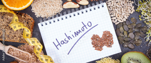Tape measure, notepad with inscription hashimoto and best ingredients for healthy thyroid. Dieting and slimming concept
