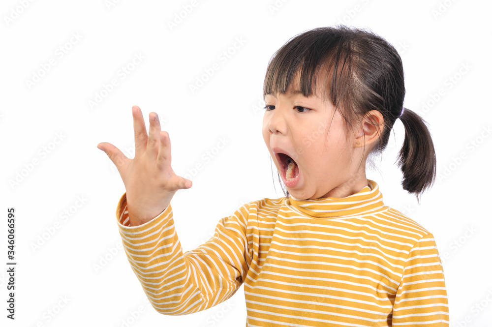 Baby health care for germs and touch concepts. A little Asian girl (5years old) shocking by bacteria on hands. Kid in yellow t-shirt with emotion face and The gestures raised both hands near face. Baby health care for germs and touch concepts. A little Asian girl (5years old) shocking by bacteria on hands. Kid in yellow t-shirt with emotion face and The gestures raised both hands near face.