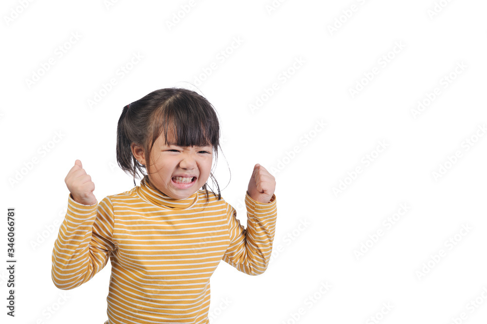 Facial expressions and emotional gestures of children concept. A little asian girl of 5 years old doing gestures and expressing very angry faces and raise a fist on white background with copy space. Facial expressions and emotional gestures of children concept. A little asian girl of 5 years old doing gestures and expressing very angry faces and raise a fist on white background with copy space.