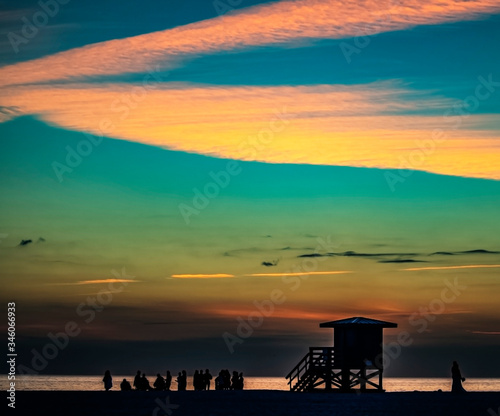 sunset at the beach, sky, sea, clouds, orange, lifeguard tower, seascape, travel, summer, dusk © Renee