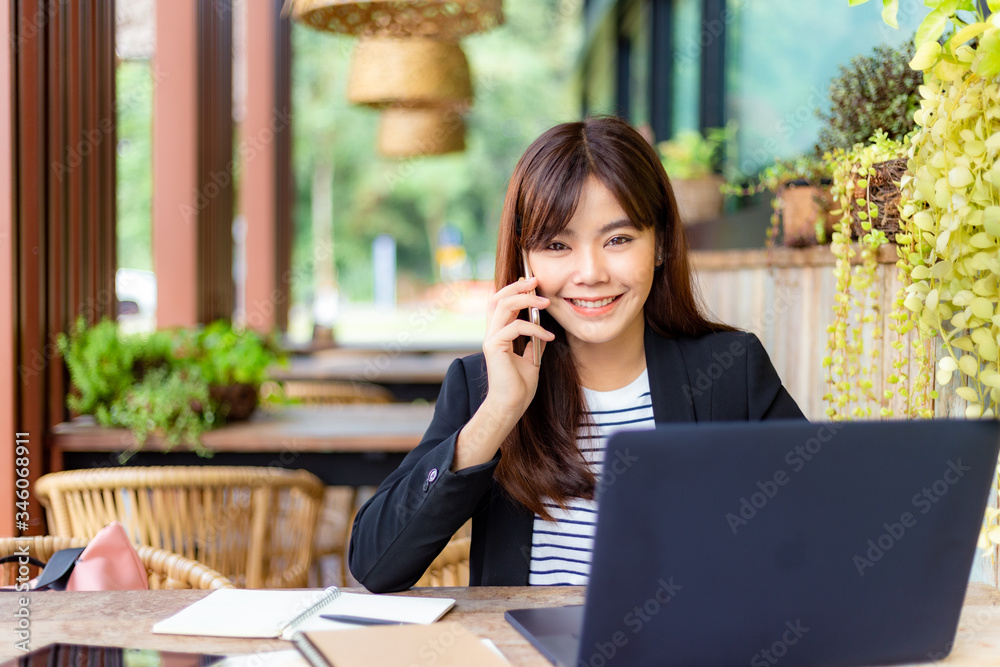 Young attractive business woman in her casual suit working on her computer at outdoor patio of her office, working mobile or young entrepreneur concept Young attractive business woman in her casual suit working on her computer at outdoor patio of her office, working mobile or young entrepreneur concept