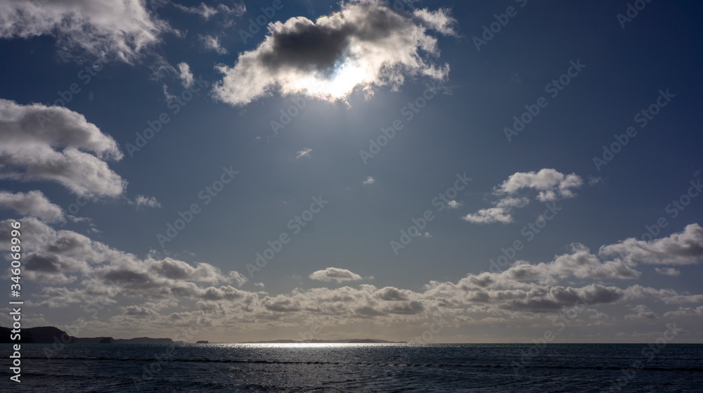 Sunburst through clouds on the sea