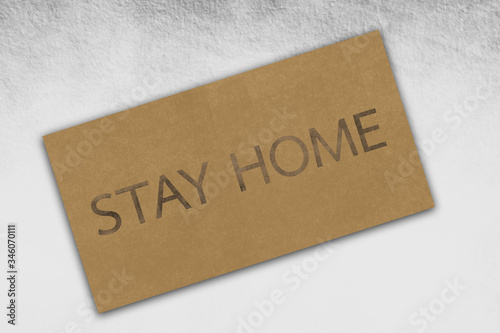 Illustration of a brown paper texture with text of stay home on vintage cardboard background