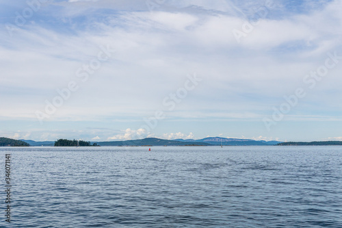 Haro strait view from Vancouver island with cloudy sky British Columbia Canada. © olegmayorov