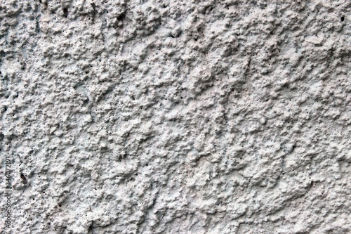 The surface of the fence is created by throwing cement and painted white.