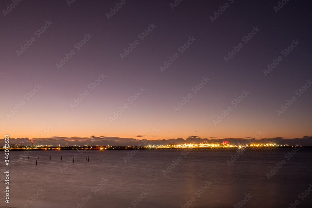 industrial port in the distance at dawn