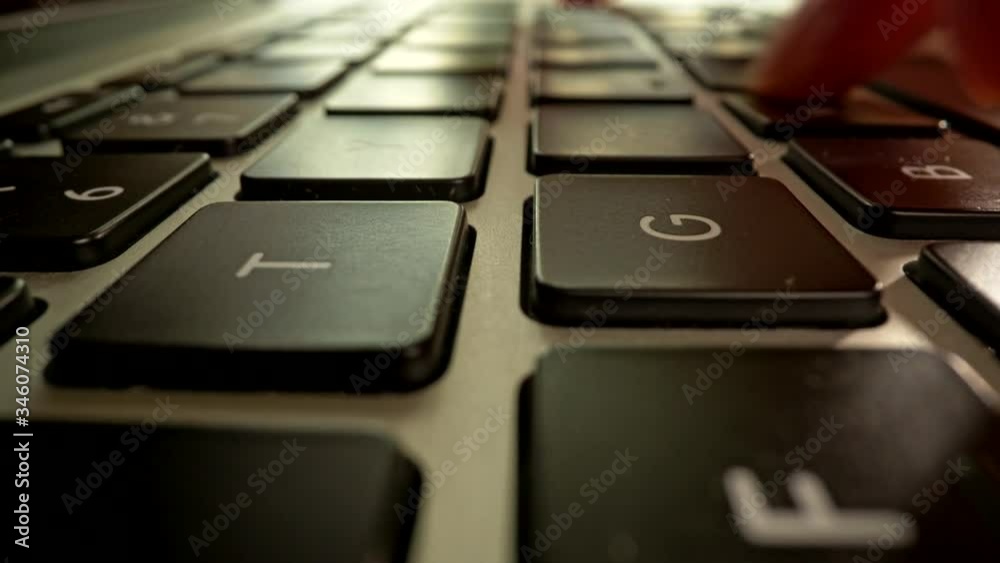 Pressing buttons of laptop. Typing on keyboard. Camera moving backwards. Slider macro shot, UHD Pressing buttons of laptop. Typing on keyboard. Camera moving backwards. Slider macro shot, UHD